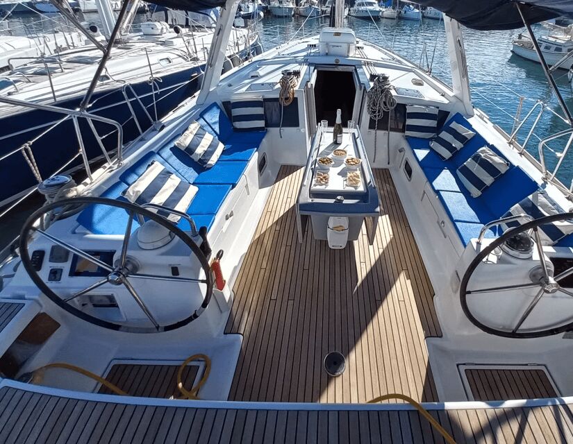 Barcelona: 2-Hour Sailboat Tour with Snacks and Drinks - The harbor stretch: mega-yachts, Maremagnum, and Columbus at water level
