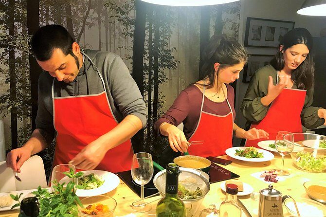 La Boqueria Market and Paella Cooking Class in Barcelona - Inside the 18th-century apartment kitchen: everyone cooks